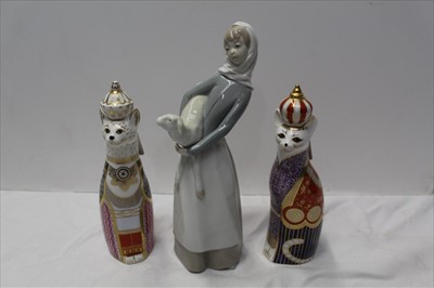 Lot 912 - Two Royal Crown Derby, Royal cats paperweights, together with a Lladro figure of a girl with a lamb (3)