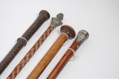 Lot 631 - Essex Regiment Interest- Silver mounted walking cane with Essex Regiment badge, together with wooden walking cane, the top inset with R.A.F. button a leather swagger stick and one other (4)