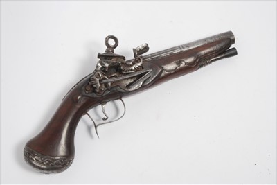 Lot 812 - 18th century Spanish 20 bore miquelet lock pistol with fluted two-stage barrel, ornate side lock and carved walnut stock with ornate steel pommel and wooden ramrod, 28cm overall