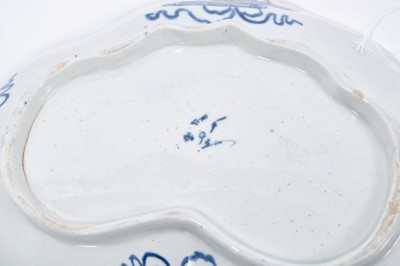 Lot 23 - Pair of Bow blue and white kidney-shaped dishes, circa 1760, the central panel painted with a fisherman, on a powder blue ground with further panels