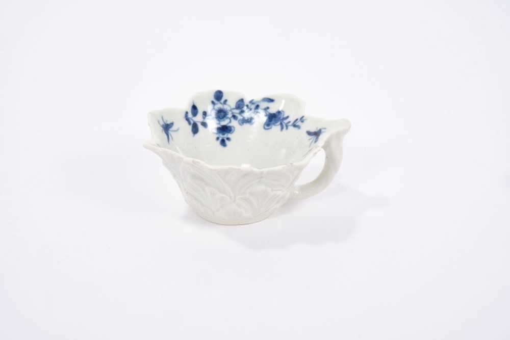 Lot 26 - Worcester blue and white butter boat, circa 1760, geranium moulded, painted with the Pickle Leaf Daisy pattern, workman's mark to the bottom of the handle, 8cm across