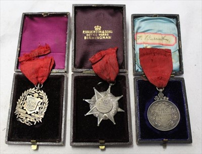 Lot 1919 - Three Victorian gymnastics medals - 1889 for rings, 1890 for champion eight, and 1890 for senior rope, with accompanying notes regarding the winner of the medals