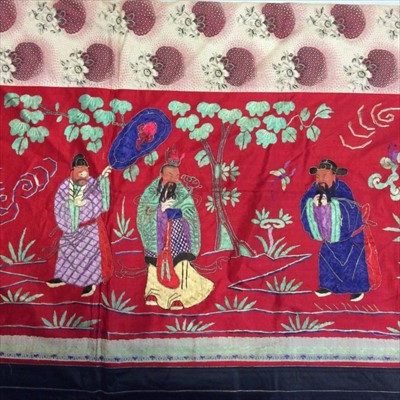 Lot 1645 - Chinese embroidered red silk panel c19th century couch and satin stitch, figures with painted faces in garden scene with black silk borders. Lined in Chinese floral printed cotton. Knotted fringe...