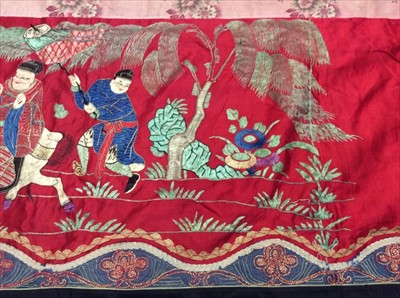 Lot 1649 - Chinese long embroidered red silk panel c19th century couch and satin stitch figures in garden scene with pagoda and horses etc. Lined with Chinese floral printed cotton with fring...