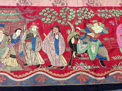 Lot 1649 - Chinese long embroidered red silk panel c19th century couch and satin stitch figures in garden scene with pagoda and horses etc. Lined with Chinese floral printed cotton with fring...