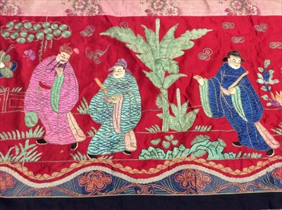 Lot 1649 - Chinese long embroidered red silk panel c19th century couch and satin stitch figures in garden scene with pagoda and horses etc. Lined with Chinese floral printed cotton with fring...