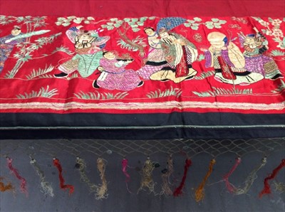 Lot 1650 - Chinese embroidered red silk panel c1900s couch and satin stitch figures in garden scene with black silk border. Lined with red cotton, knotted fringing, metal beads and tassels. Possibly a...