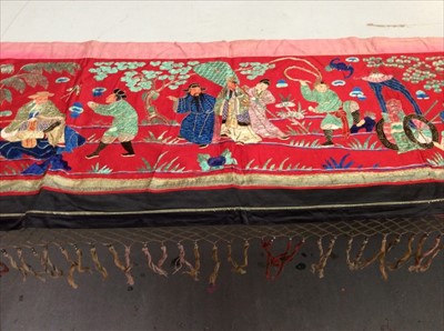 Lot 1651 - Chinese embroidered red silk panel c19th century, couch and satin stitch figures in garden scene with black silk border. Lined with red cotton, knotted fringing, metal beads and tassels. Possibly a...