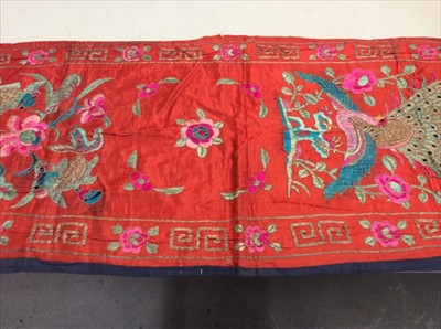 Lot 1656 - Chinese embroidered red silk vertical banner c1900s. Couch and satin stitches. Large peacock and flowers, scrolling foliage and flower border. Lined in blue cotton.