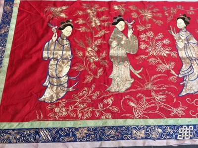 Lot 1661 - Chinese long embroidered red silk panel c1900s couch and satin stitch, figures in garden scene with altar. Embroidered silk border with symbols and flowers. Unlined.