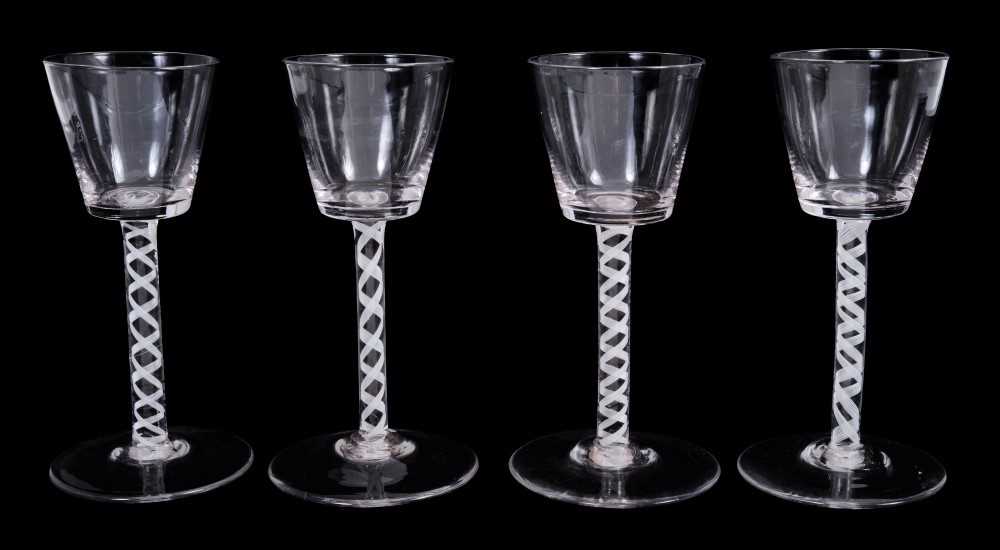 Lot 12 - Near set of four Georgian-style wine glasses, possibly continental, with bucket bowls and opaque twist stems