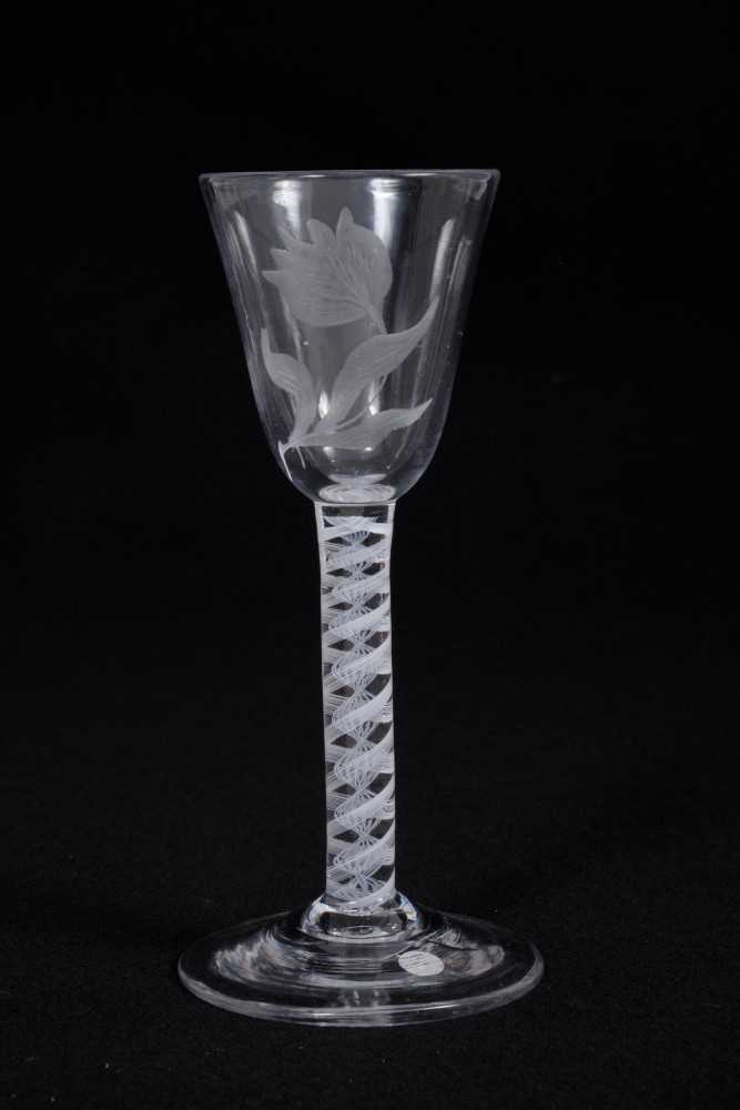 Lot 5 - Georgian wine glass, the round funnel bowl engraved with a flower, on a double series opaque twist stem, above a conical foot, circa 1760, 15cm height