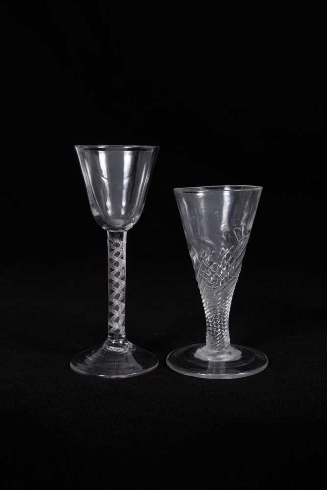 Lot 13 - 18th century wine glass, the round funnel bowl on an air twist stem, above a high pointed conical foot, together with an 18th century ale glass with wrythen stem (2)