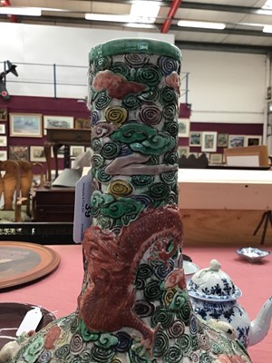 Lot 39 - Chinese famille verte reticulated bottle vase, decorated in relief with immortals and a dragon, six character seal mark to base, with a carved hardwood stand, vase measures 35cm height
