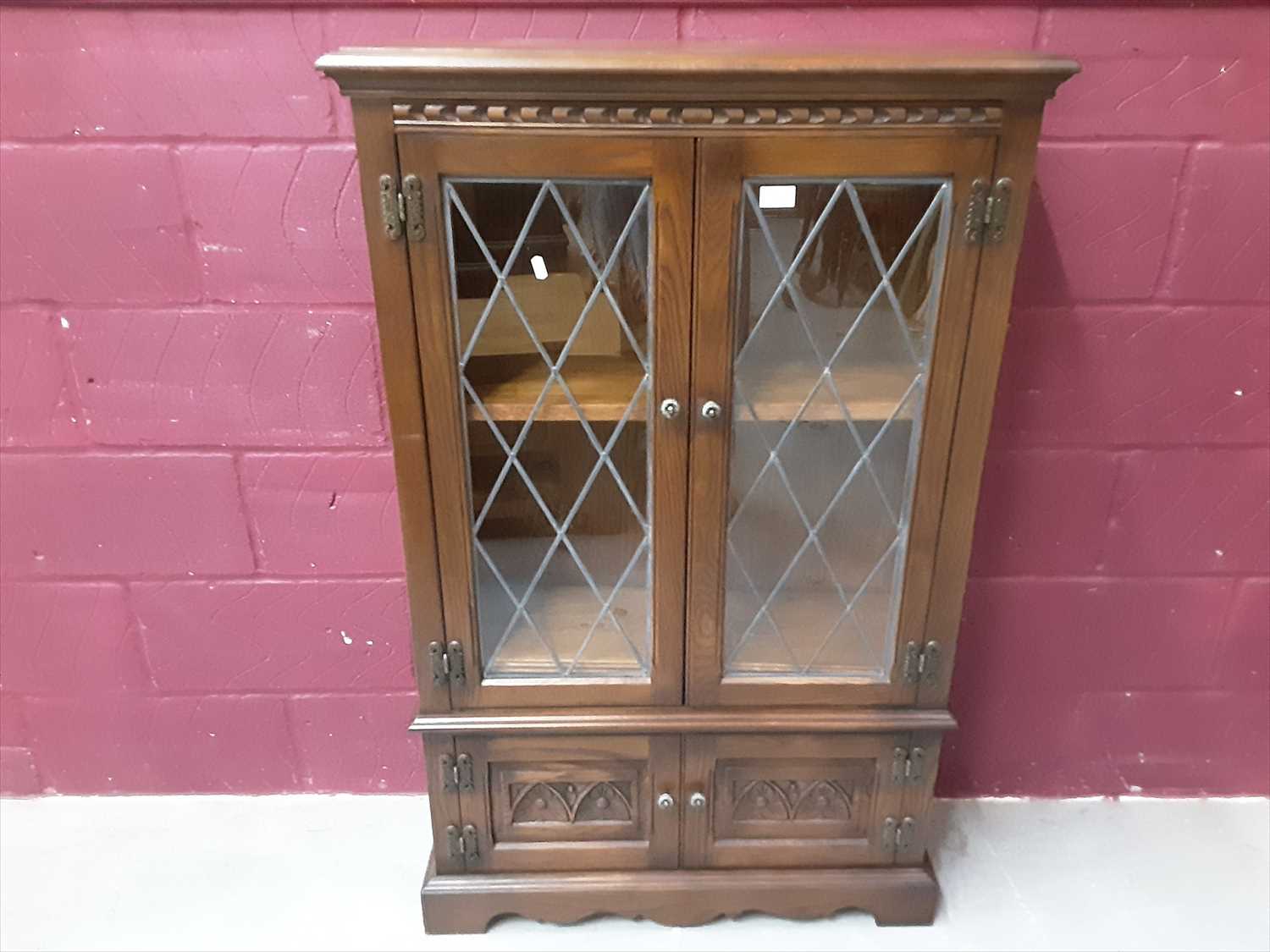 Lot 862 - Old Charm style oak bookcase with two leaded glazed doors and two carved panelled doors below