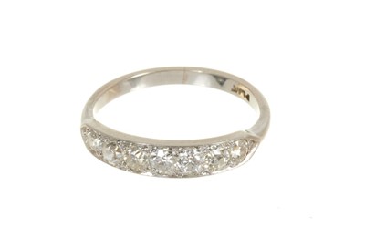 Lot 448 - Diamond seven stone half hoop ring