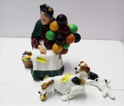 Lot 916 - Two Royal Doulton Dogs together with a Royal Doulton figure "The Old Balloon Seller" HN1315 (3)