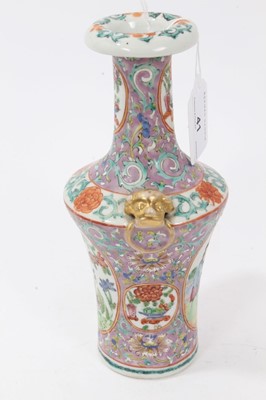 Lot 41 - 19th century Chinese famille rose Canton porcelain vase, decorated with panels of figures and flowers, on a lilac ground, with mask and ring handles, 20.5cm height