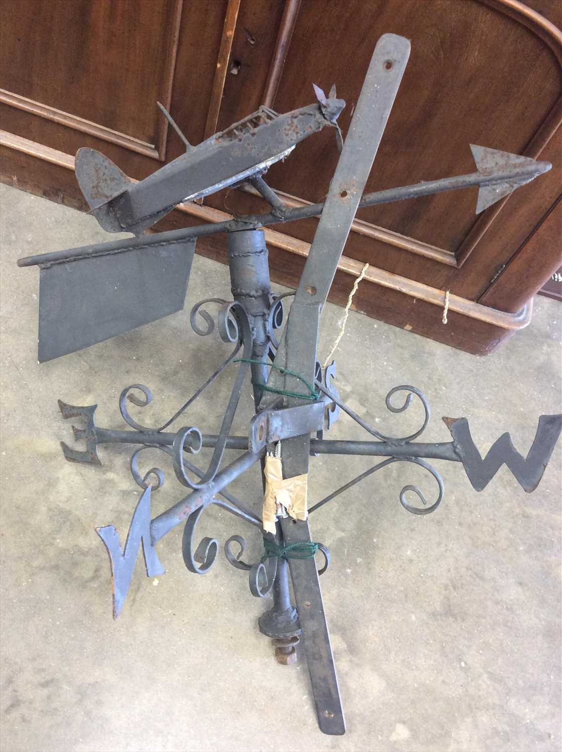 Lot 420 - Wrought iron weather vain with Hurricane Bomber surmount, brass wall mounted bell and watering can