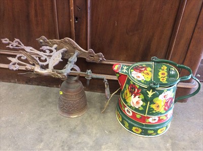 Lot 420 - Wrought iron weather vain with Hurricane Bomber surmount, brass wall mounted bell and watering can