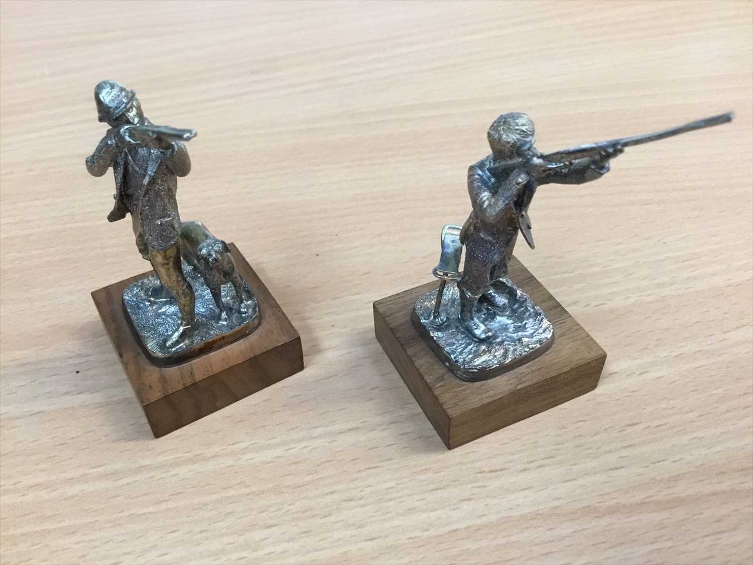 Lot 667 - Pair of silver models of men shooting