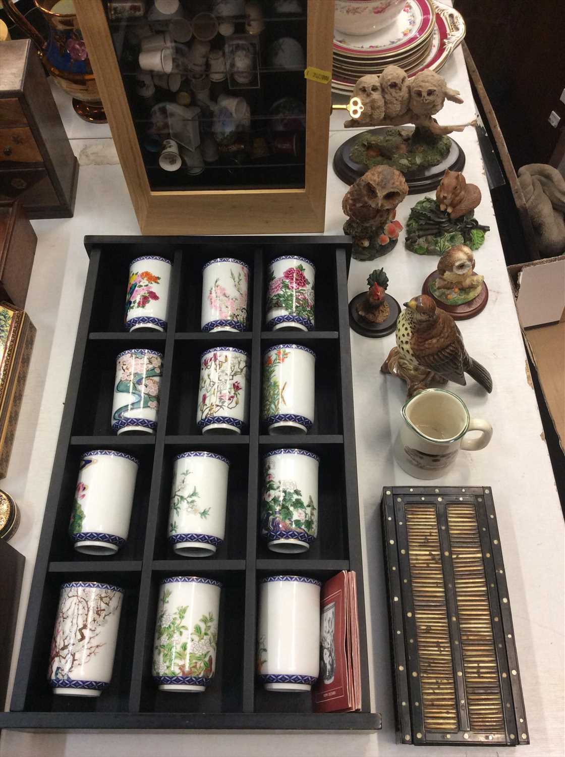 Lot 460 - Collection ceramic thimbles in display case, Oriental cabinet cups, owl ornaments and porcupine quill box