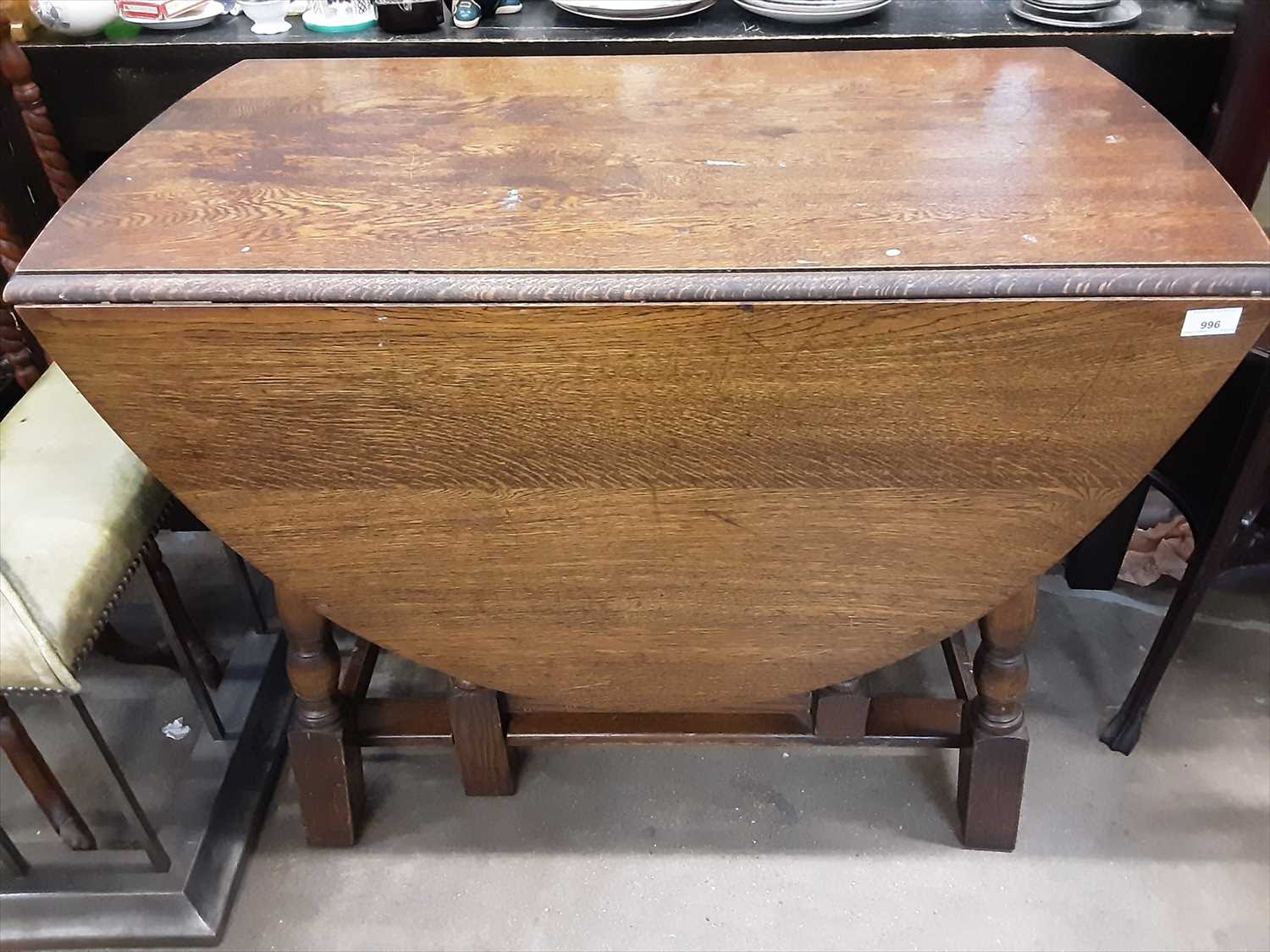 Lot 996 - Oak oval drop leaf dining table on turned and block legs