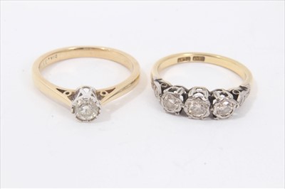 Lot 132 - 18ct gold diamond three stone ring in platinum illusion setting together with a similarly set diamond single stone ring (2)