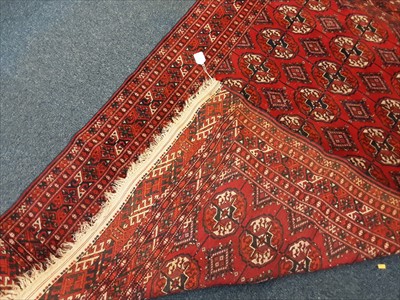 Lot 1072 - Eastern rug with geometric decoration on red ground