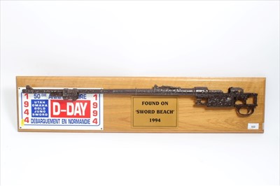 Lot 822 - Second World War Battlefield Relic recovered from Sword beach, a heavily corroded rifle barrel, mounted with plaque on oak shield