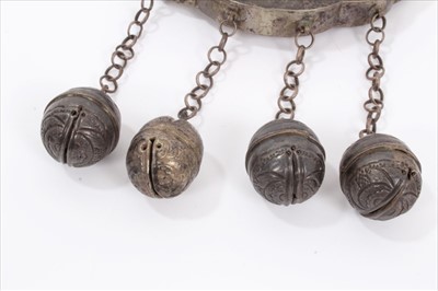 Lot 4 - Old Chinese white metal necklace with embossed panel depicting figures and Chinese characters, with chain and bells