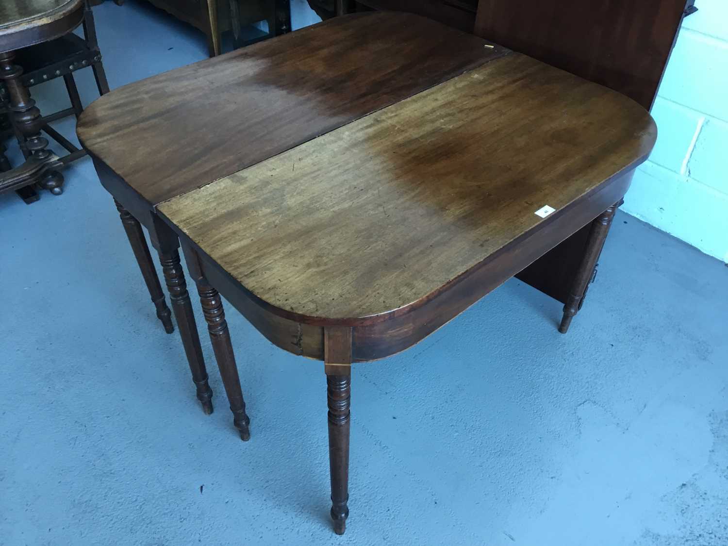 Lot 40 - Georgian Mahogany D - end dining table with one extra leaf, on turned legs, 109cm in width, 104cm in length (without leaf) 72cm in height