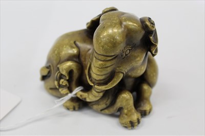 Lot 1933 - Indo-Chinese bronze and gold splash model of an elephant in recumbent pose 10cm long