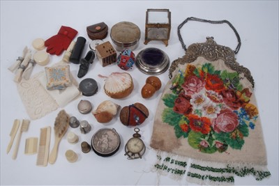 Lot 1684 - A selection of antique sewing items including novelty pin cushions, tapes measures, thimbles and thimble cases.  Elaborate white metal frame handbag with floral micro beading.