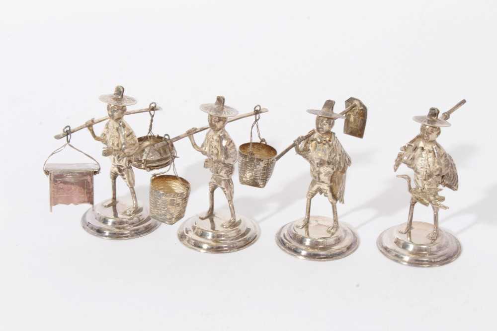 Lot 227 - Four Contemporary Far Eastern silver figures in the form of various tradesmen.