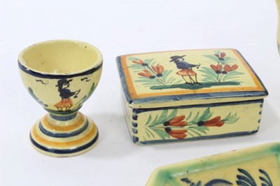 Lot 86 - Collection of Quimper faience pottery, painted with figures and foliate patterns on a yellow ground, including a teapot, egg cup, boxes, dish and a ramekin, all marked