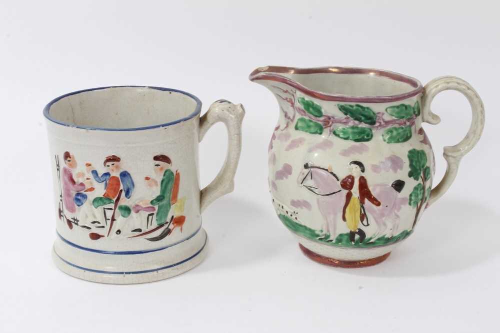 Lot 87 - 19th century Sunderland purple lustre jug, decorated in relief with an equestrian scene, and a pottery frog mug decorated with tavern scenes