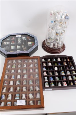 Lot 983 - Selection of porcelain thimbles housed in display cabinets and a glass dome, plus two silver thimbles