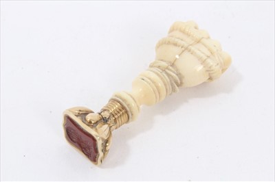 Lot 198 - 19th century carved ivory seal in the form of a clenched fist gripping a serpent with carved carnelian intaglio