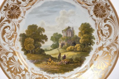 Lot 54 - Pair of early 19th century Crown Derby plates, each painted with landscape scenes, one of Derbyshire and the other of Italy, both marked to base, 22.5cm diameter