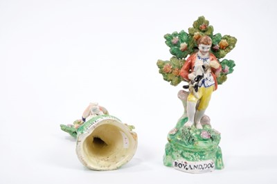 Lot 144 - Charming pair of Staffordshire pearlware figures, c.1820, showing a boy and girl with a dog and lamb, standing on grassy mounds with bocage behind them, with titles at the bottoms