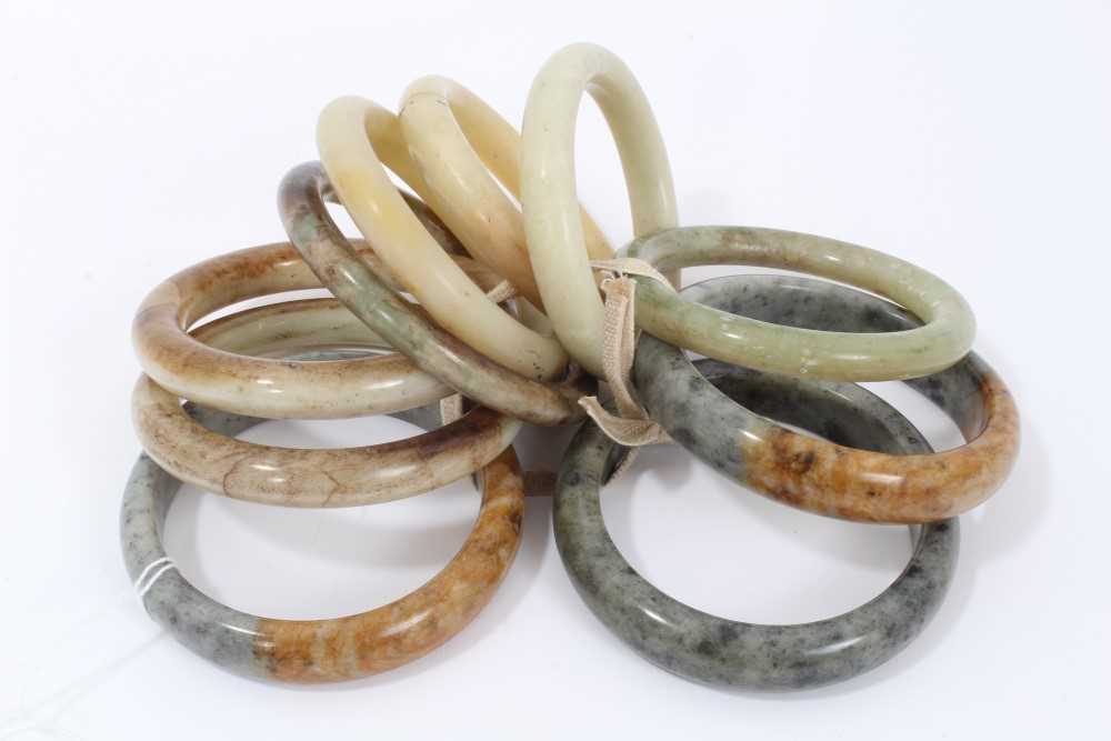Lot 10 - Ten jade/green hard stone polished bangles