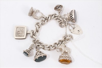 Lot 263 - Silver curb link charm bracelet with various seal fob charms