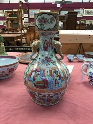 Lot 48 - 19th century Chinese Canton famille rose garlic form porcelain bottle vase, with elephant mask handles, finely painted with panels of figures