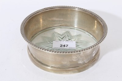 Lot 247 - Edwardian silver wine coaster of circular form, with flared gadrooned border.