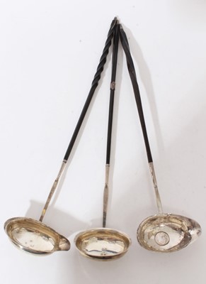 Lot 338 - Three George III silver toddy ladles
