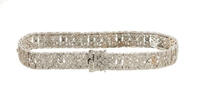 Lot 457 - Art Deco style diamond bracelet, the articulated panels with a geometric pattern set with brilliant cut diamonds in 18ct white  gold mille grain setting. Estimated total diamond weight approximatel...