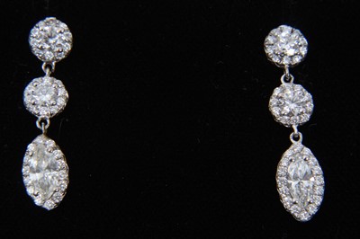 Lot 459 - Pair of diamond pendant earrings, each with a marquise cut diamond surrounded by a border of brilliant cut diamonds suspended from two round brilliant cut diamond clusters. Estimated total diamond...