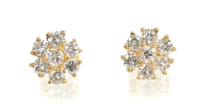 Lot 465 - Pair of diamond cluster earrings, each flower head cluster with seven brilliant cut diamonds in gold claw setting. Estimated total diamond weight approximately 1.10 carats