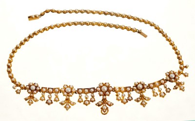 Lot 462 - Late Victorian gold and seed pearl fringe necklace, the articulated links with flower head clusters and graduated foliate border